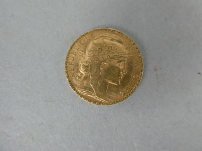 a gold coin with a picture of a woman on it