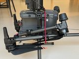 a small camera attached to a tripod in the middle of a room