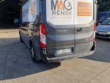 the van is parked in front of the garage with the door open