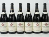 six bottles of wine are lined up in a row on a table