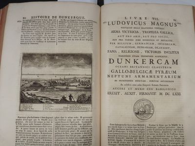 an open book with a picture of a town in the middle of it