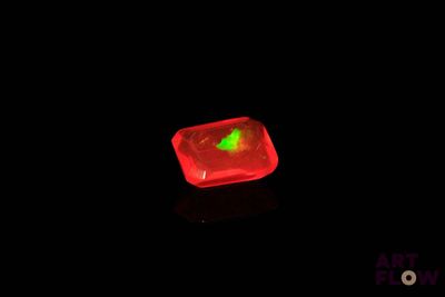 a red light in the middle of a black background