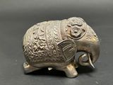 an elephant figurine with a decorative design on it ' s back