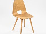 a wooden chair that has a hole in the back of it