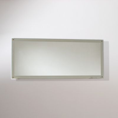 a mirror on the wall above a toilet in a bathroom
