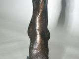 sculpture of a hand on a black base on a white background