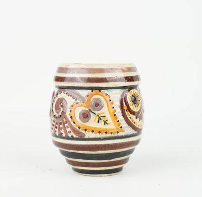 a close up of a cup on a white surface