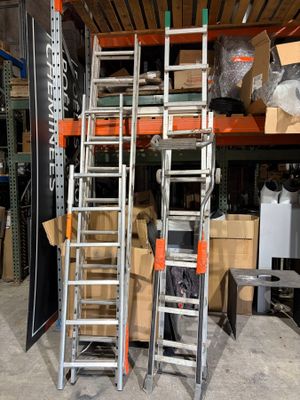 several ladders are stacked on top of each other in a warehouse
