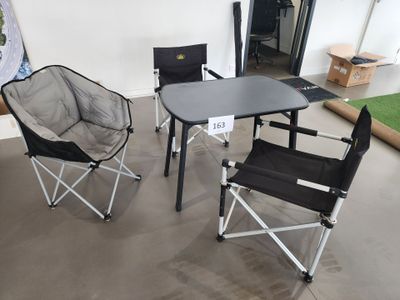 three folding chairs and a table in a room with a painting on the wall