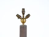a small brass object on a marble pedestal with a white background