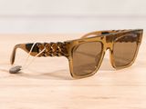 sunglasses on a wooden table with a string attached to them