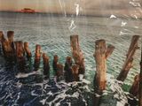 a picture of a picture of an ocean with a ship in the background