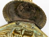 a close up of a gold clock with a face on it