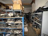 a room filled with lots of metal items and a refrigerator