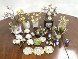 a table with a bunch of vases and flowers on it