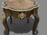 a small table with a marble top on a gray surface
