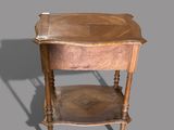 a small wooden table with a drawer on top of it