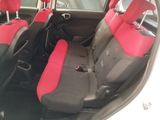 a picture of the interior of a car with red and black seats