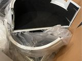 a white toilet sitting inside of a box on the floor
