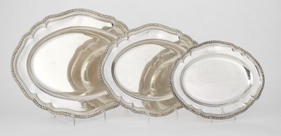 four silver plate set with beaded rims on a white background