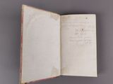an open book with writing on it sitting on a table