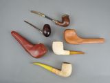 several different types of smoking pipes are lined up on a table