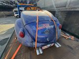 a blue vw buggy with an american flag on the back