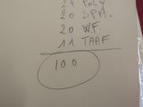 a piece of paper with writing on it sitting on a table