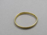 a close up of a gold ring on a white surface