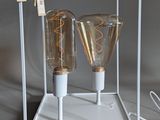 two light bulbs that are sitting inside of a glass box