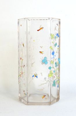 a glass vase with a flower design on it