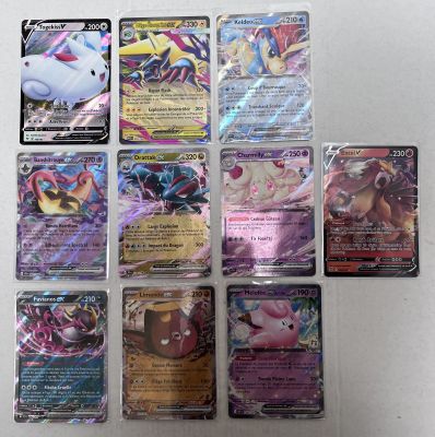 several pokemon cards sitting on top of each other on a table