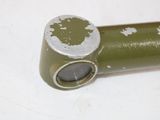 a green tube with a hole in it on a white surface