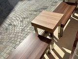 two wooden benches sitting on the side of the street