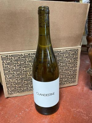 a bottle of wine sitting on a table next to a box