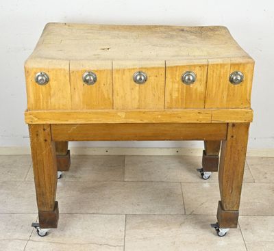 a small wooden table with four drawers on it