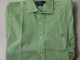 a green and white striped shirt sitting on top of a table