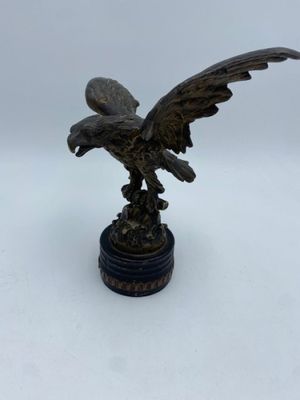 an image of a bronze statue of an eagle on a pedestal