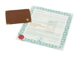 a certificate with a wax seal on it next to a piece of paper