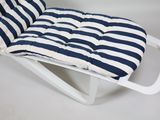 a white chair with a blue and white striped seat pad