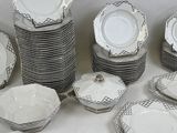 a lot of plates and bowls on the table