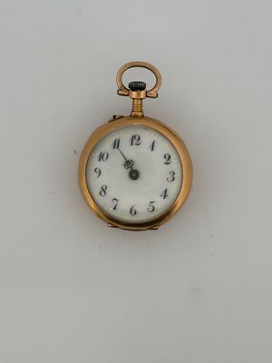 a gold pocket watch with a white face on a white surface