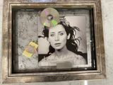 a picture of a woman with a cd in a picture frame