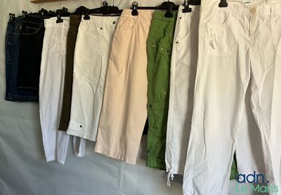 five pairs of pants hanging on a clothes rack
