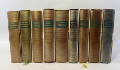 six old books are lined up in a row on a white surface