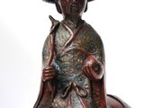 bronze statue of a man sitting on a horse with a hat on his head