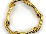 a close up of a gold ring on a white surface