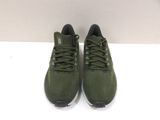 a pair of green sneakers on a white surface