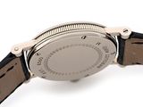 a close up of a watch on a white surface