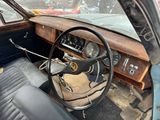 a steering wheel and dashboard of a car in a parking lot